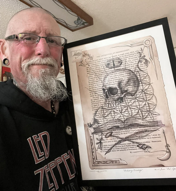 Unlocking Knowledge surrealist art print by Juan Sepulveda, displayed in a black frame and held by a customer.
