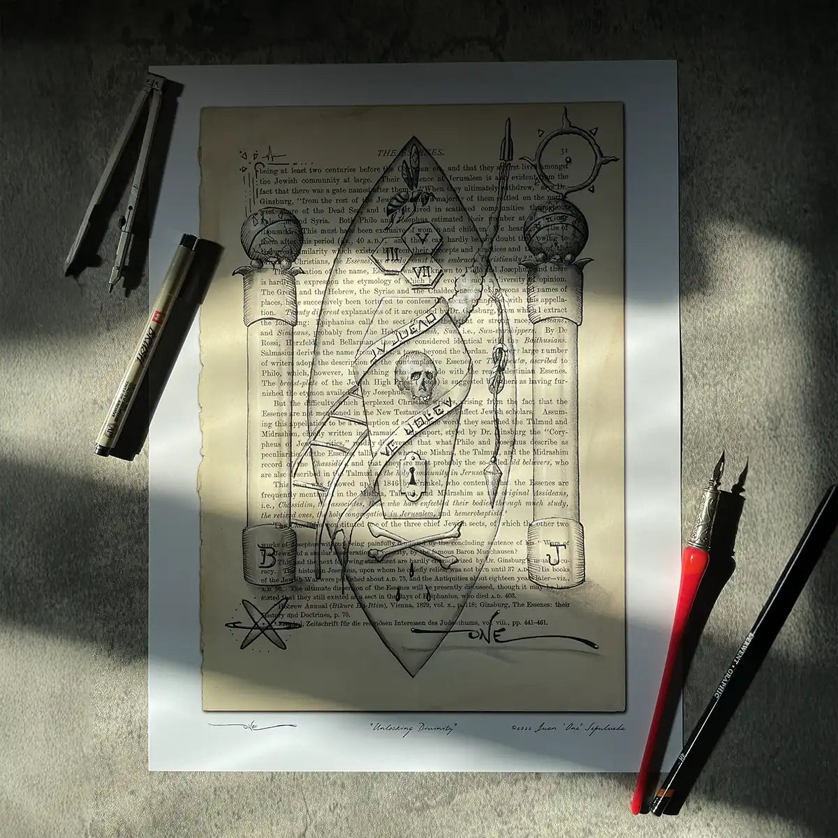 Unlocking Divinity unframed print styled on stone surface with art tools and natural window light